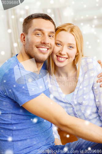 Image of happy couple hugging at home