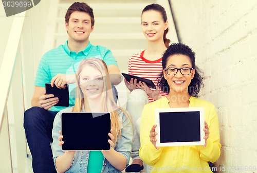 Image of smiling students showing tablet pc blank screen