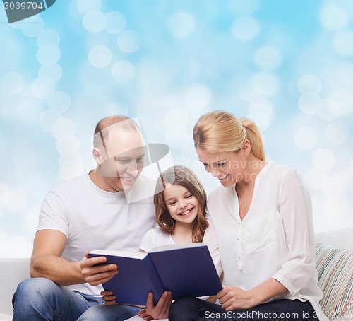 Image of happy family with book at home