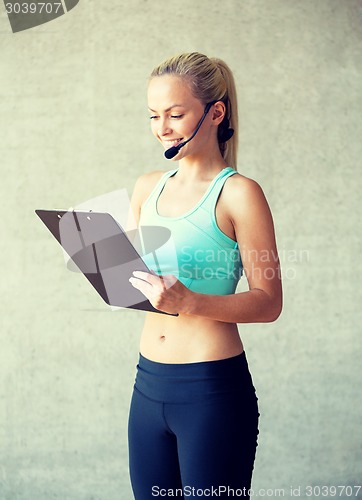 Image of beautiful athletic woman in gym