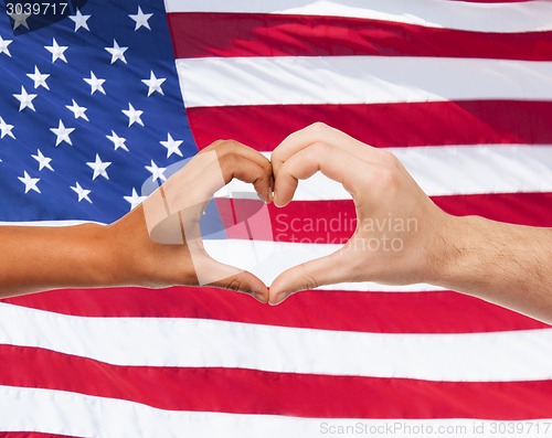 Image of close up of hands showing heart shape