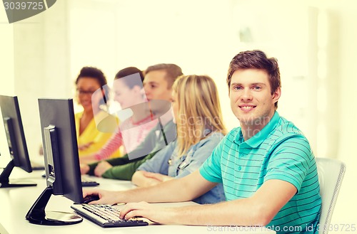 Image of male student with classmates in computer class