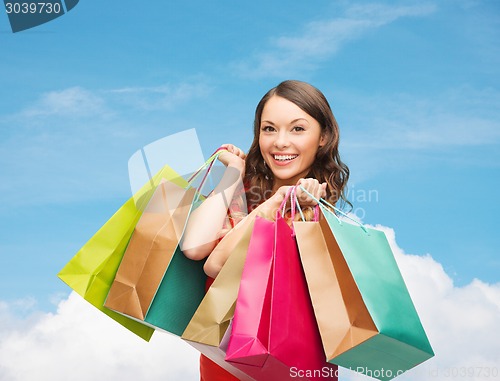 Image of smiling woman with colorful shopping bags