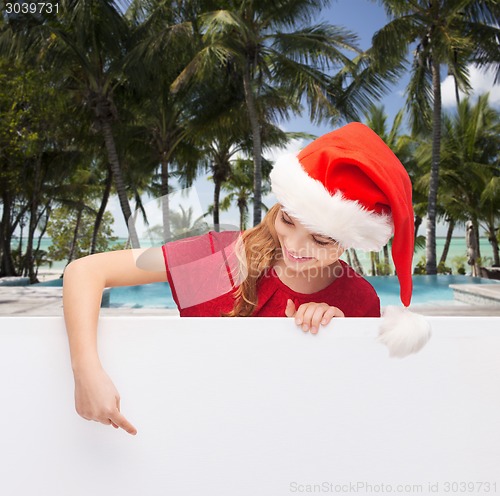 Image of girl in santa helper hat with blank white board