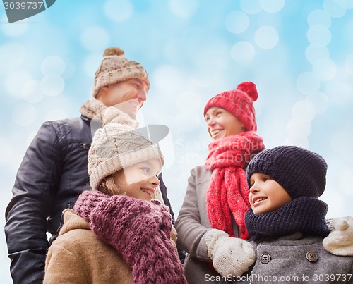 Image of happy family in winter clothes outdoors