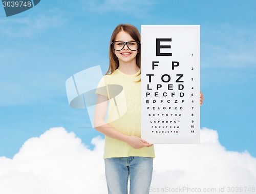 Image of little girl in eyeglasses with eye checking chart