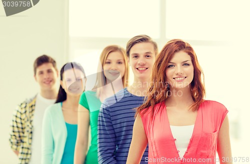 Image of smiling students with teenage girl in front