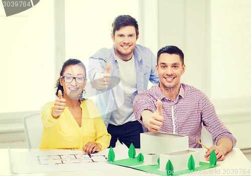 Image of smiling architects working in office