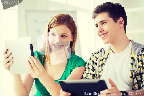 Image of smiling students with tablet pc at school