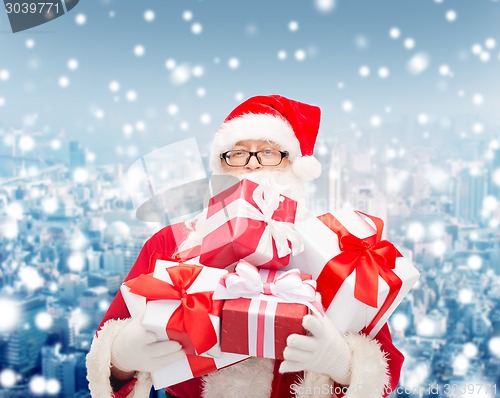 Image of man in costume of santa claus with gift boxes