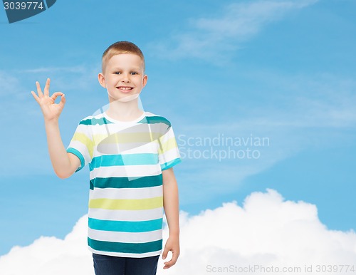 Image of little boy in casual clothes making ok gesture
