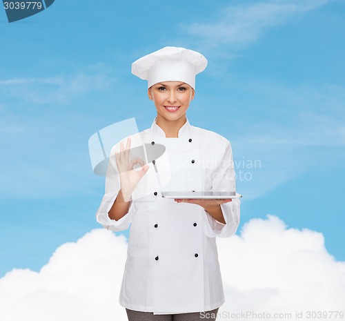 Image of smiling female chef with tablet pc computer