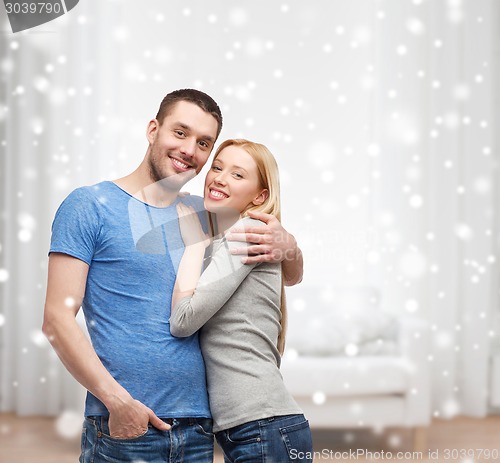 Image of happy couple hugging at home