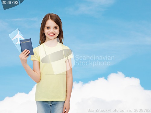 Image of smiling little girl with ticket and passport