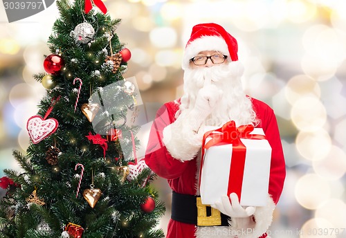 Image of man in costume of santa claus with gift box