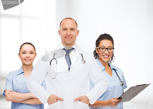 Image of group of smiling doctors with clipboard