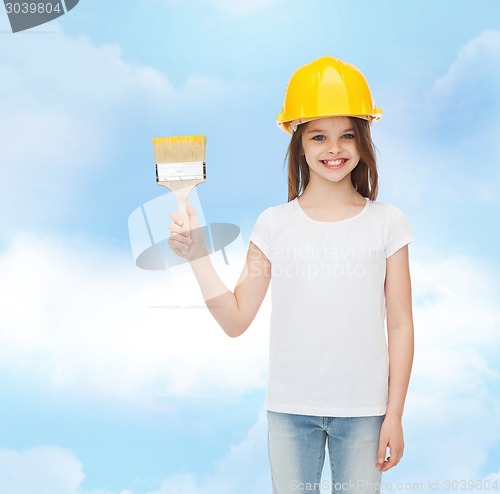 Image of smiling little girl in helmet with paint brush