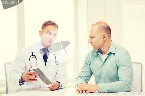 Image of doctor with tablet pc and patient in hospital