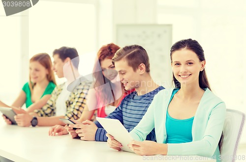 Image of smiling students with tablet pc at school