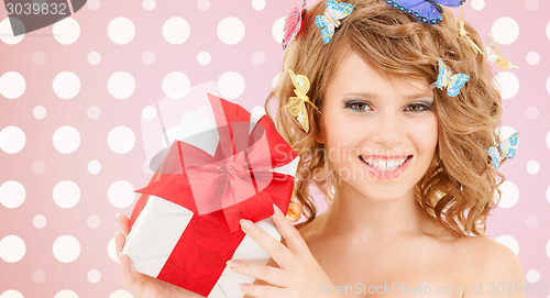 Image of smiling young woman with gift box