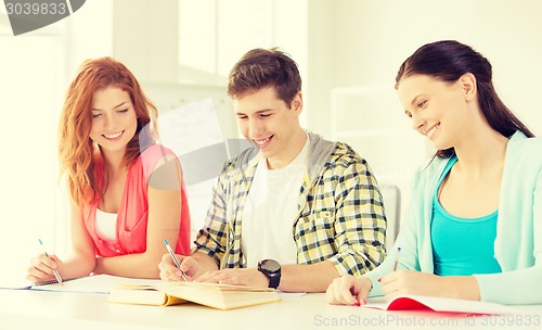 Image of students with textbooks and books at school