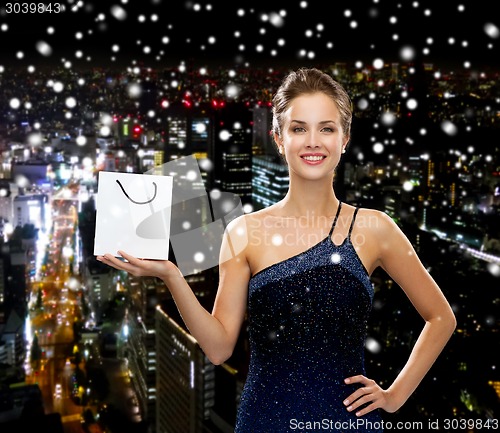 Image of smiling woman with white blank shopping bag