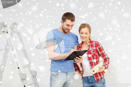 Image of smiling couple with clipboard and wallpaper roll