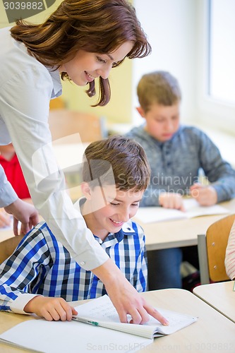 Image of group of school kids writing test in classroom