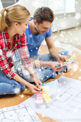 Image of smiling couple selecting color from samples