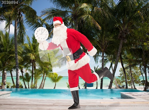 Image of man in costume of santa claus with clock