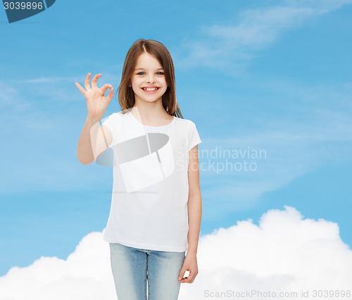 Image of smiling little girl in white blank t-shirt