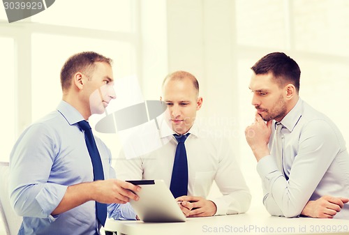 Image of business team working with tablet pc in office