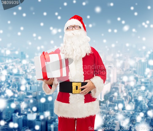 Image of man in costume of santa claus with gift box