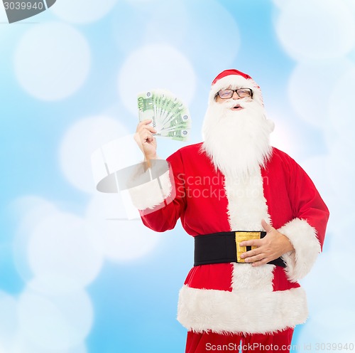 Image of man in costume of santa claus with euro money