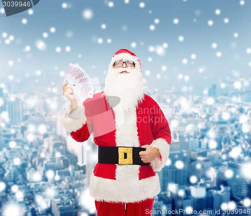 Image of man in costume of santa claus with euro money