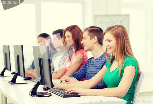 Image of female student with classmates in computer class