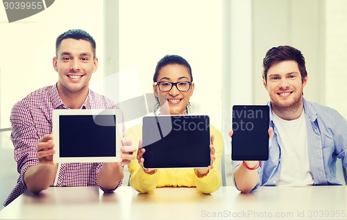Image of smiling colleagues showing tablet pc blank screen
