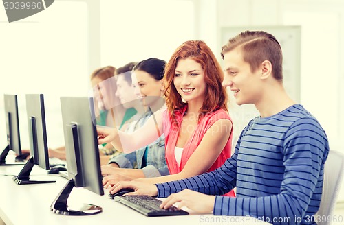 Image of female student with classmates in computer class