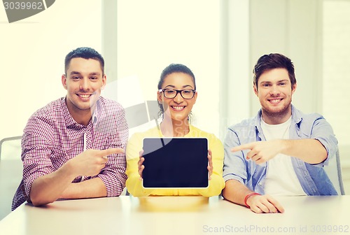 Image of smiling colleagues showing tablet pc blank screen
