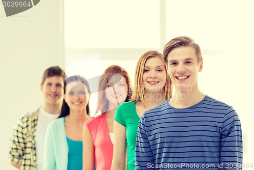 Image of smiling students with teenage boy in front