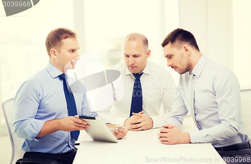 Image of business team working with tablet pc in office