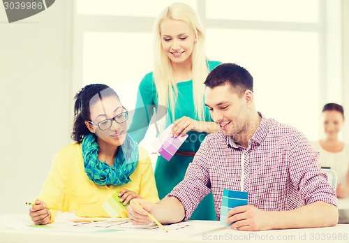 Image of smiling interior designers working in office