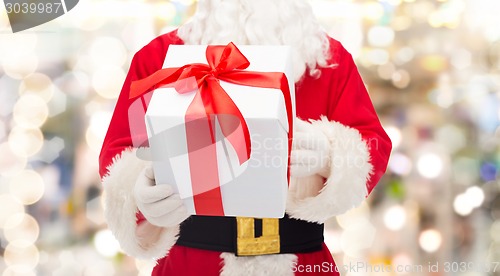 Image of man in costume of santa claus with gift box