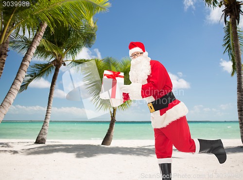 Image of man in costume of santa claus with gift box