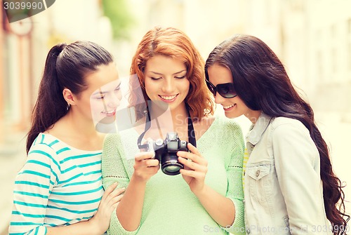 Image of smiling teenage girls with camera