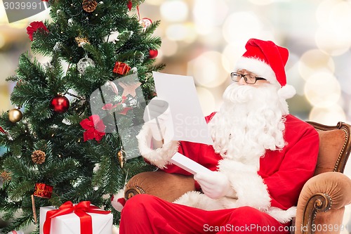 Image of man in costume of santa claus with letter