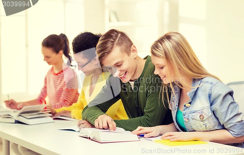 Image of students with textbooks and books at school