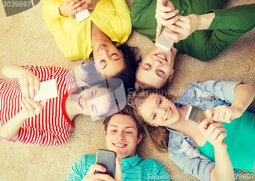 Image of group of smiling people lying down on floor