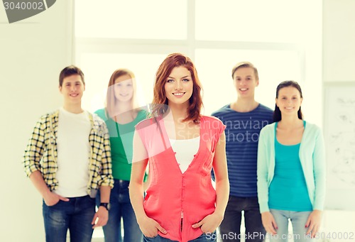 Image of smiling students with teenage girl in front