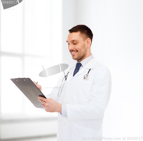 Image of smiling male doctor with clipboard and stethoscope